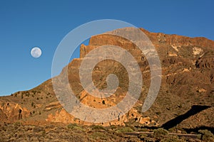 Beautiful view of the mountain ridge at sunset with full moon on