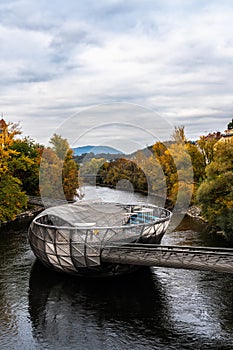 Beautiful view of Murinsel island on the Mur river in autumn, Graz, Austria