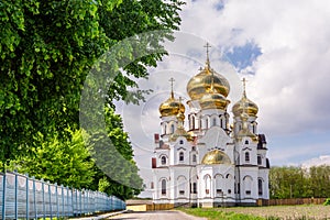 A beautiful view of the new church of All Saints in the village of Onyshkivtsi, Rivne region, Ukraine, near the lake of St. photo