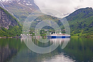 Beautiful view at a the norwegian village Geiranger with a cruise ship