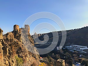 Beautiful view of the old fortress overlooking the botanical garden. Old Tbilisi, winter in the city