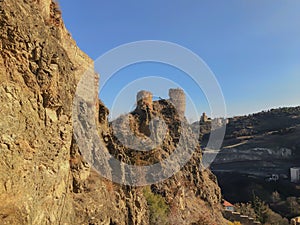 Beautiful view of the old fortress overlooking the botanical garden. Old Tbilisi, winter in the city