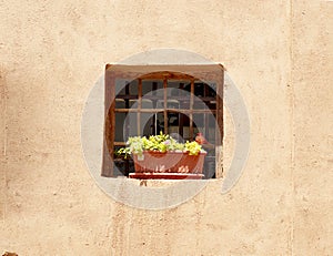 Beautiful view of an old thatched wall with a window decorated with wood and a beautiful vase, Yazd, Iran