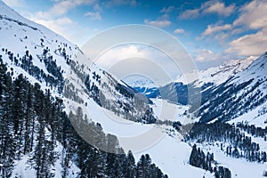 Beautiful view over frozen mountain lake in the Alps in winter time