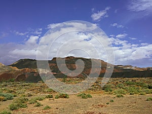 Beautiful view overlooking rusty red desert, distant mountains in Fuerteventura island, Canaries, Spain