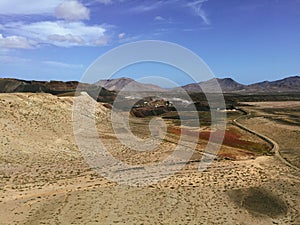 Beautiful view overlooking rusty red desert, distant mountains in Fuerteventura island, Canaries, Spain