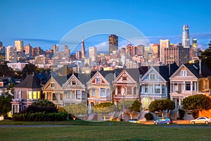 Beautiful view of Painted Ladies, colorful Victorian houses located near scenic Alamo Square in a row, on a summer day with blue