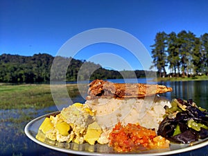 beautiful view of the Patenggang lake in Indonesia in the morning while having breakfast photo