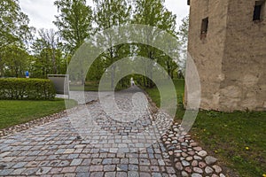 Beautiful view of pavement in park lined with old cobblestones in historic center.