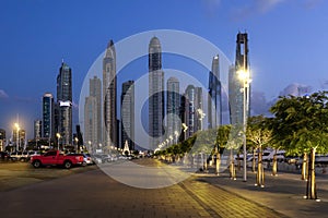 Beautiful view of pedestrian walkway in district Dubai Marina in evening night illuminations