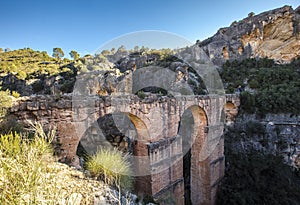 Beautiful view of the Pena Cortada Bridge among the mountains captured in Chelva, Valencia, Spain photo