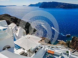 Beautiful view of picturesque village of Oia with traditional white architecture and windmills in Santorini island. Greece. Vacati