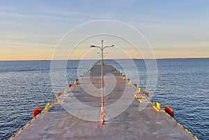 Beautiful view of a pier sunset in Tallinn. Blue sky landscape. Estonia marine at evening.