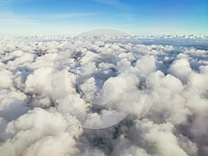 A beautiful view from the plane to white voluminous fluffy thunderclouds and the space of the stratosphere, top view