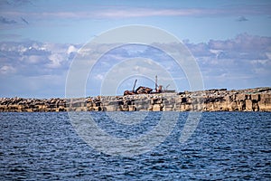 Beautiful view of the Plassey shipwreck on the rocky beach of  Inis Oirr island seen from a boatrful sunny day with a blue
