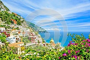 Beautiful view on Positano on Amalfi coast with blurred flowers on foreground