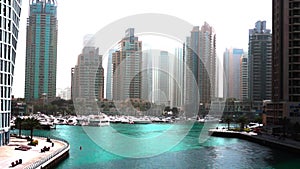 Beautiful view from Promenade on Dubai Marina, floating yachts and boats.