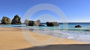 Beautiful view of Ribeiro do Cavalo Beach with rock formations in the sea in Portugal photo