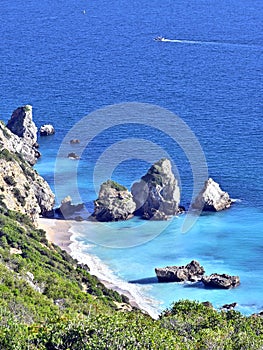 Beautiful view of Ribeiro do Cavalo Beach with rock formations in the sea in Portugal photo