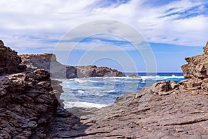 Beautiful view of a rocky bay with waves on the sea on the island of Menorca, Balearic islands, Spain