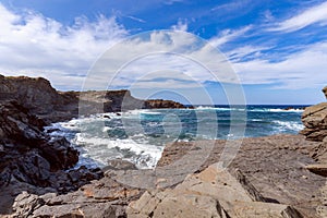 Beautiful view of a rocky bay with waves on the sea on the island of Menorca, Balearic islands, Spain