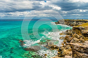 Beautiful view of rocky cliff and turquoise water at sunrise on the the southern part of the Isla Mujeres in Caribbean photo