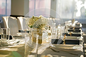 Beautiful view of rolled blue table napkins with ribbon on a table set up