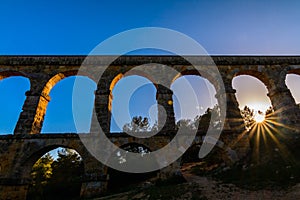 Beautiful view of roman Aqueduct Pont del Diable in Tarragona at sunset