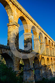 Beautiful view of roman Aqueduct Pont del Diable in Tarragona at sunset