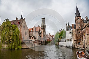 Beautiful view of the Rozenhoedkaai canal in Bruges with the belfry in the background