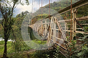 Beautiful view on rusty metal bridge over river in mountains