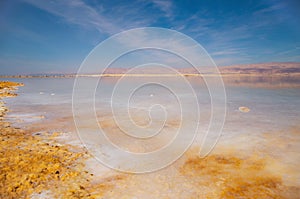 Beautiful view of salty Dead Sea shore with clear water and blue sky