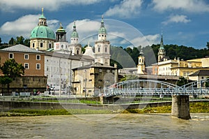 Beautiful view of Salzburg skyline with Festung Hohensalzburg and Salzach river in summer with dramatic cloudscape, Salzburg,