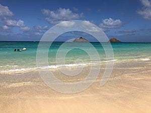 Beautiful view of sandy Lanikai Beach in Kailua, Hawaii under blue sky