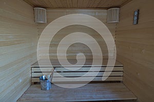 Beautiful view of sauna room interior. Wooden walls and seats. Health concept.