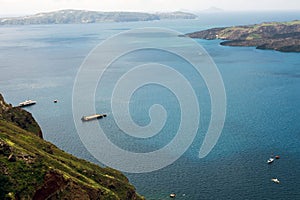 Beautiful view of the sea, the ship, the volcano on a warm sunny day. Photos from the observation deck of the Greek city of Fira