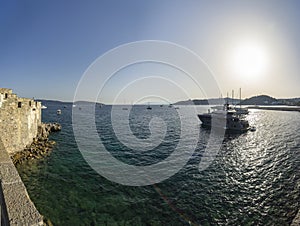 Beautiful view of the sea ships and the setting sun Bodrum fortress Turkey