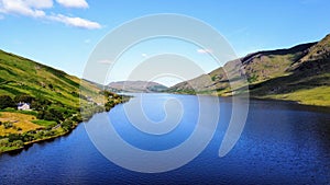 Beautiful view of the serene blue waters surrounded by majestic mountains. Ireland