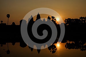 Beautiful view of the silhouette Angkor wat and its reflection in the lake at sunrise