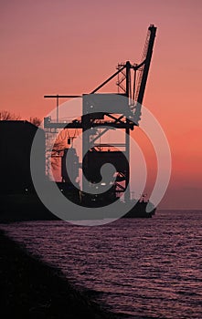 Beautiful view of the Silhouette of a Crane, Thermal Powerstation at the Elbe during sunrise