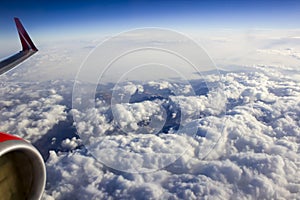 Beautiful view of the sky from the porthole, engine and wing, clouds during the flight