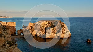 Beautiful view of the small island near the beach Praia JoÃ£o de Arens in Algarve, Portugal