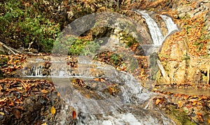 Beautiful view of small waterfall in autumn forest