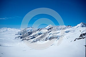 Beautiful view of snow mountain above cloud with clear blue sky looking from viewpoint, Jungfrau, Switzerland