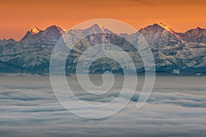 Beautiful view of snowy mountain peaks above clouds