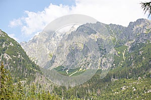 Beautiful view of soft white clouds covering tall mountain peaks in the High Tatras range