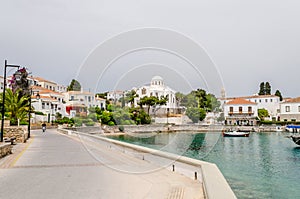 Beautiful View of Spetses Town with Traditional Neoclassic Buildings and White Cathedral Church by the Sea