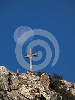 Beautiful view of a steel cross standing on Penarroya-Pueblonuevo rock in Cordoba, Spain