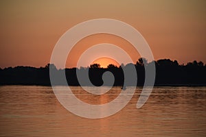 The view of the sunrise over the meadows and great river.