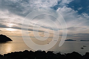 Beautiful view of sunset at beach with people kayaking.